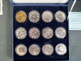 a box of silver and gold coins on a table