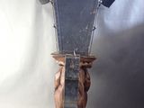 a wooden clock that is on a stand on a white background