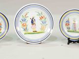 five plates and two cups and a pitcher on a table