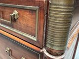 a close up of a wooden dresser with a marble top