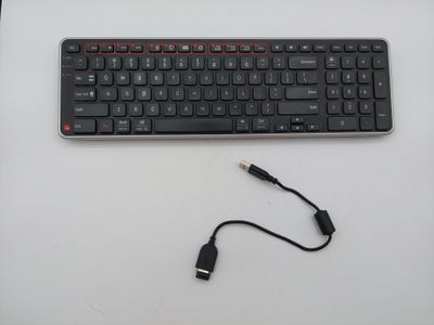 a computer keyboard and a usb cable connected to it