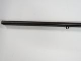 a black gun on a white surface with a white background