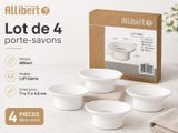 four white bowls are sitting on a table in front of a box