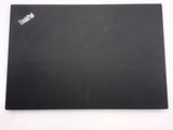 the back of a black laptop computer sitting on top of a white table