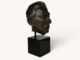 an image of a bronze bust of a man on a black stand