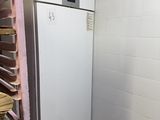 a white refrigerator in the corner of a room