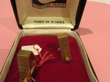 a box with a pair of cuff rings inside of it
