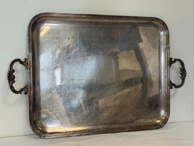 a silver tray with a mirror on it on a table