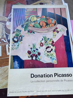 painting of a bowl of fruit on a table next to a pile of papers