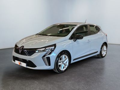 a silver car is parked in a room with a white wall
