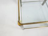 brass and glass coffee table with a square glass top