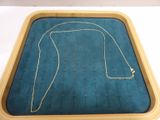 a blue tray with a necklace on it on a table