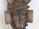 an image of a wooden mask with horns on it ' s head