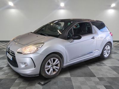 a picture of a silver citrole car parked in a garage