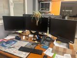 a desk with two computer monitors and a keyboard