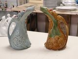 two vases that are sitting on a table