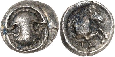 a close up of a coin with a face on it