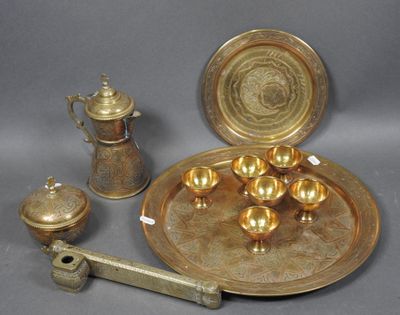 a gold plate with a silver tray and a silver cup