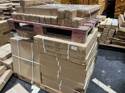 many boxes stacked on top of each other in a warehouse