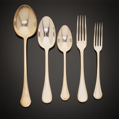 a set of five forks and spoons on a black background