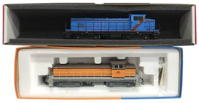 un train bleu et orange dans une boîte posée sur une surface blanche