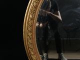 a man that is standing in front of a mirror