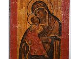 an old wooden icon of the virgin and child