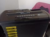 a black and yellow printer sitting on top of a white desk