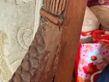 someone is sitting on a couch with a wooden arm rest on it