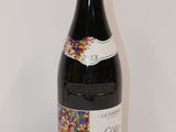 the bottle of wine has sprinkles on it on a table