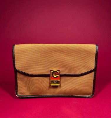 a brown and black purse sitting on top of a red surface