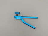 a close up of a blue pliers on a white surface