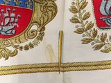 an open book with two coats of arms and a ship on it