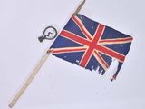 a small british flag on a stick and a key