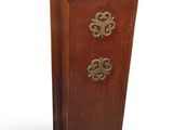a small wooden cabinet with three drawers and a clock on it