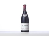 a bottle of red wine sitting on top of a table