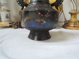 a vase that is sitting on a table next to a lamp