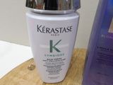 a bottle of kerastase and a box of hair products on a table