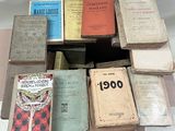 many old books stacked on top of each other on a table