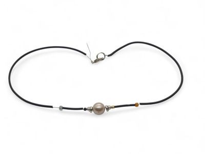 a black cord bracelet with a pearl bead and a silver clasp