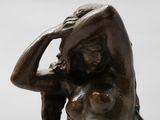 statue of a woman holding her head in her hands