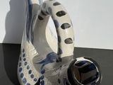 a white vase with a blue and black design on it