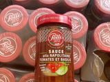 a jar of sauce sitting on top of a pile of packages