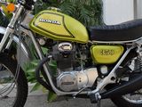 a green and black motorcycle parked in front of a building