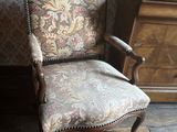 a chair that is next to a dresser in a room