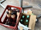 bottles of beer in a cart on the floor next to a table