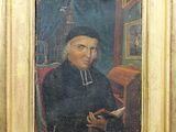 portrait of a man with a book in a gold frame