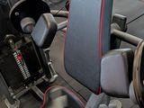 an image of a gym room with a bench, weights, and other equipment
