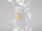 une figurine en verre représentant un dinosaure, munie d'une étiquette