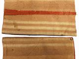 two pieces of cloth with stripes on them on a white surface